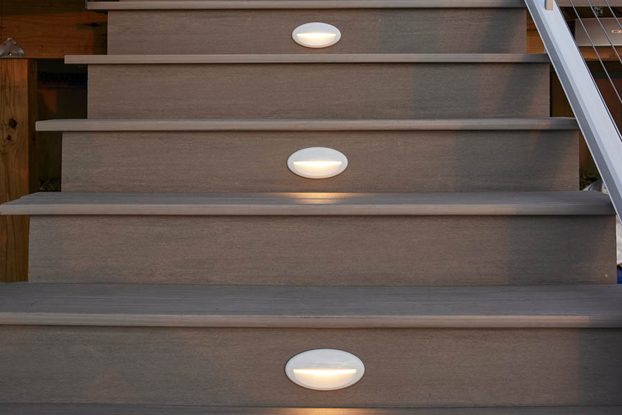 Deck lights include white riser lights in gray composite deck stairs