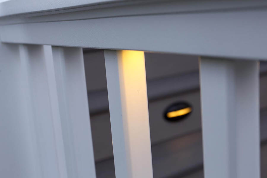 Deck lights include a under-rail light in a white composite railing