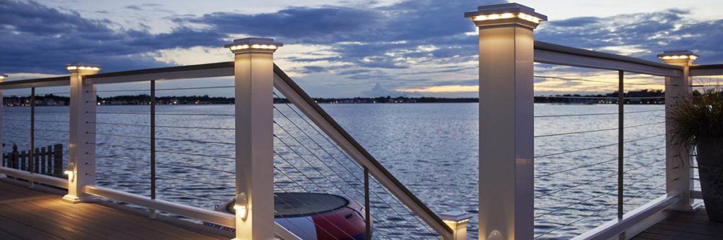 Lighting for deck posts include island cap lights in a white drink rail