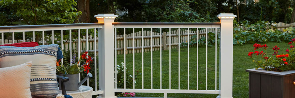 Deck post lights in the island cap on a white composite drink rail