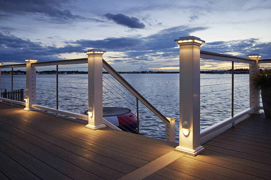 Outdoor deck lighting ideas include lights in the top and bottom of railing posts