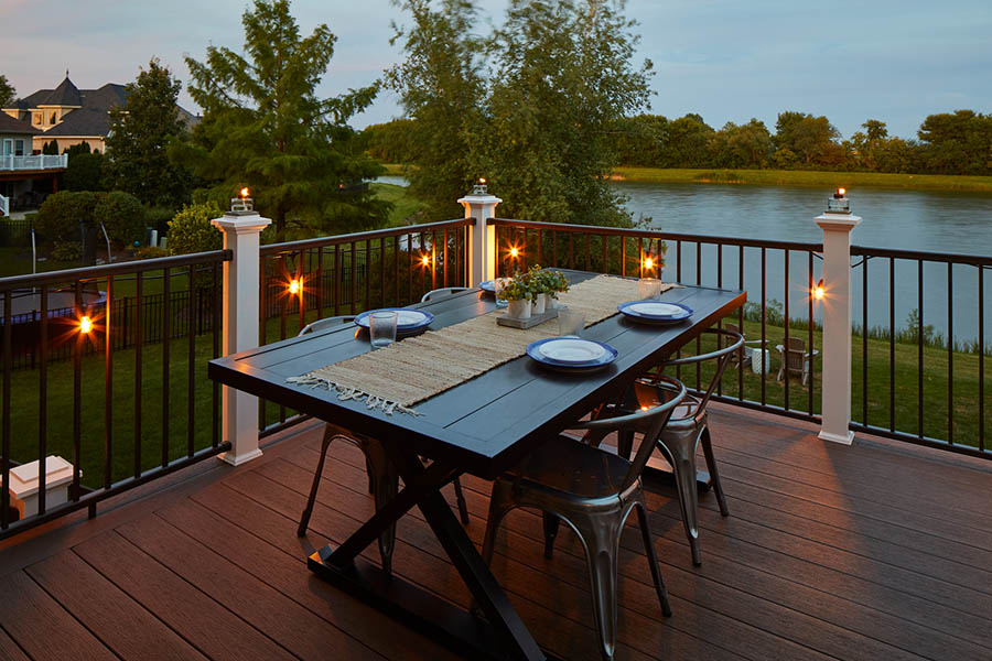 Outdoor deck lighting ideas include string lights hung along your railing
