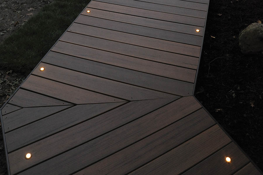 Outdoor deck lighting ideas include in-deck lights in a deck pathway