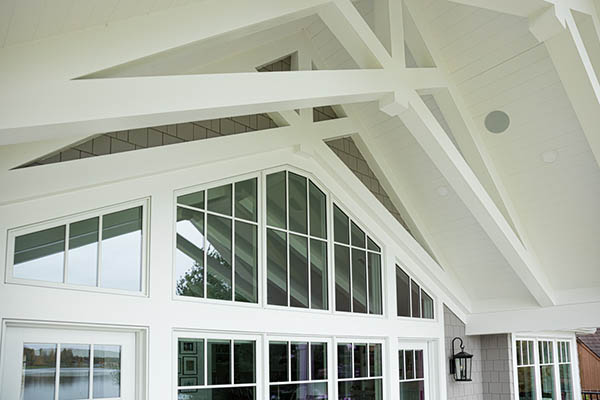 Unique crossbeams add interest to a pitched gable roof extension