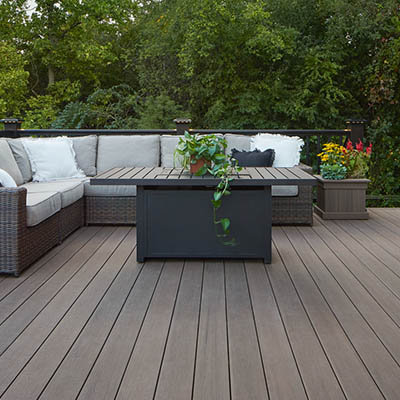 A composite pool deck made with richly hued American Walnut capped polymer decking