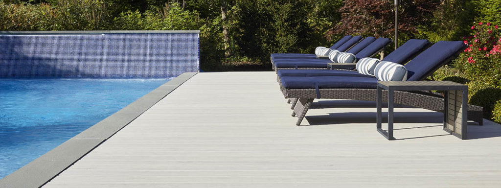 A white composite pool deck made with Whitewash Cedar boards