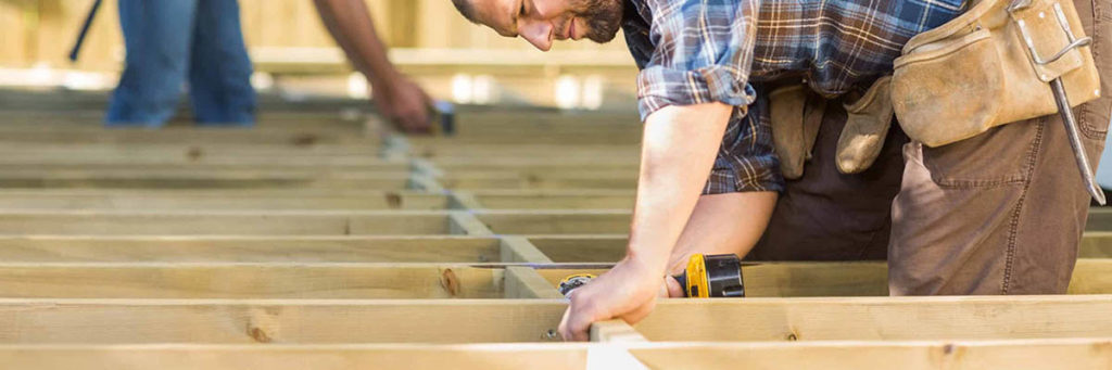 Local deck contractors work on a deck substructure