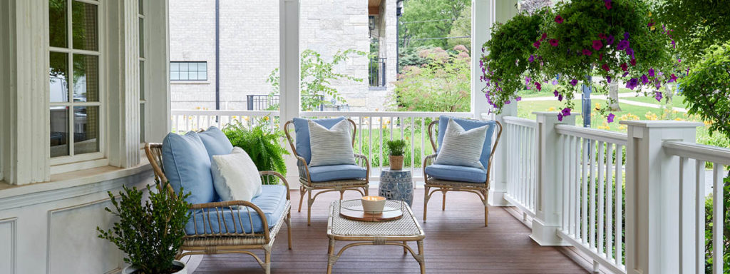 Front porch decorating ideas include hanging planters with trailing plants