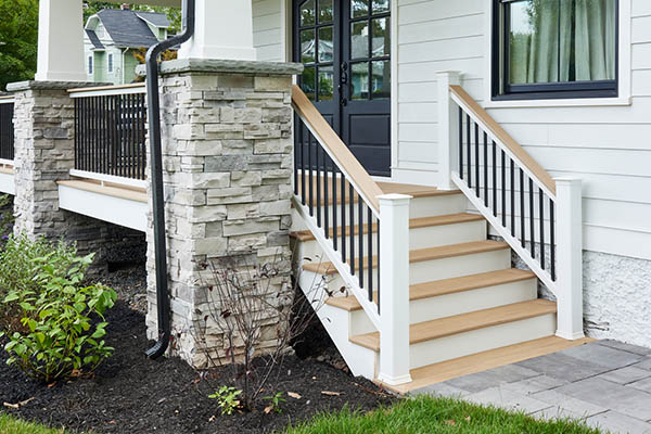 Front porch deck ideas include a mixed material railing like Drink Rail