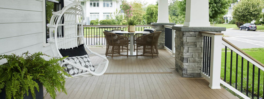 A Scandinavian-inspired porch features modern front porch ideas like a dining area