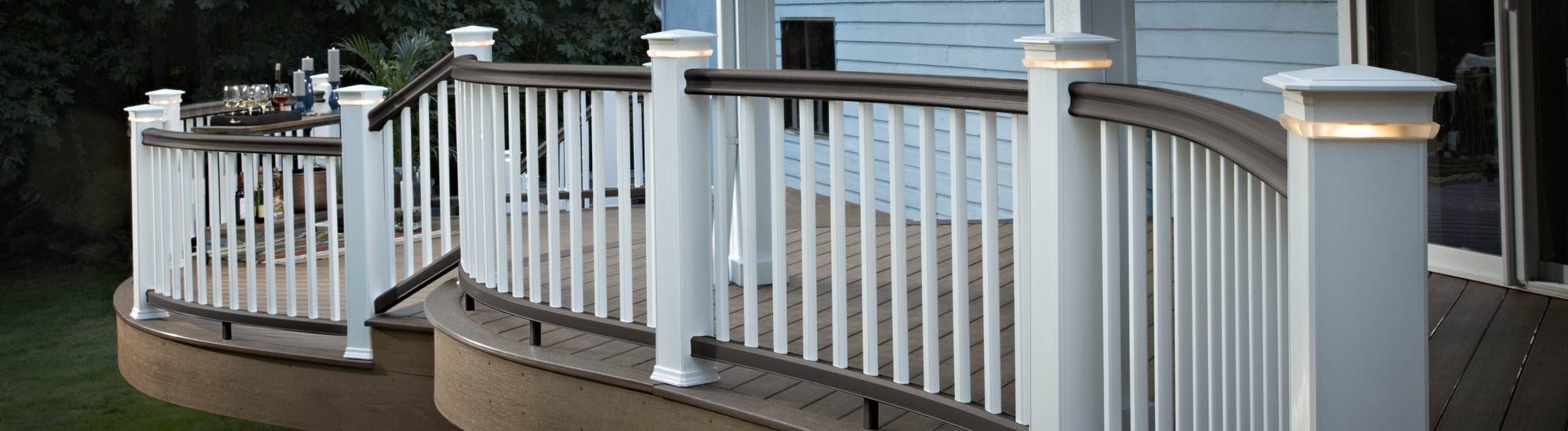A composite deck featuring English Walnut decking and Matte Espresso Classic Composite Series Railing