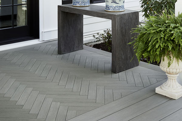 Backyard deck design ideas include a herringbone inlay pattern