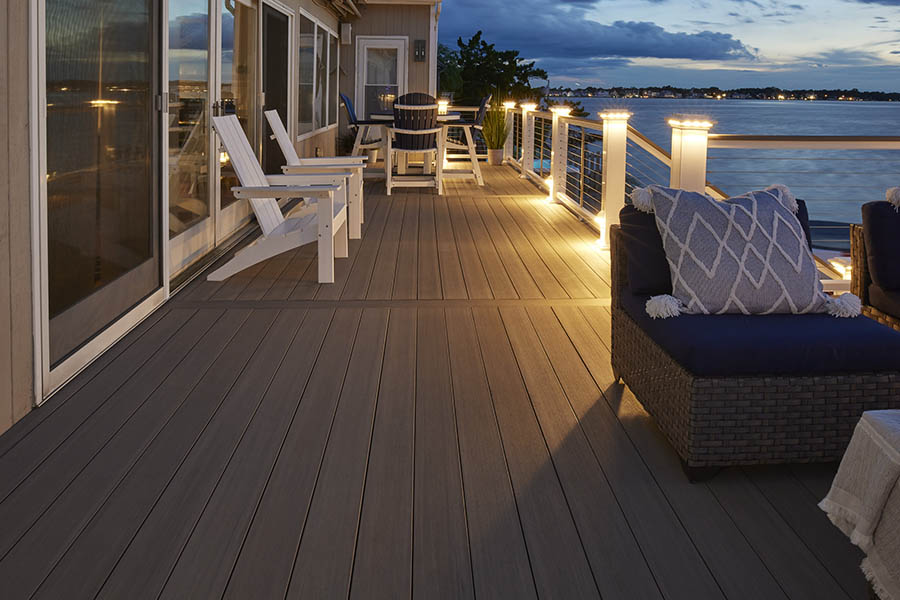 Backyard deck design ideas include built-in lighting in the railing