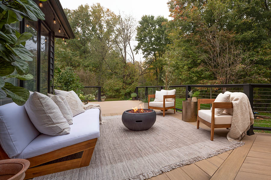 Backyard deck design ideas include a cozy outdoor living room set up