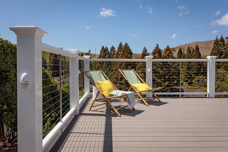 Composite deck railing with a cable rail infill on a high-rise composite deck