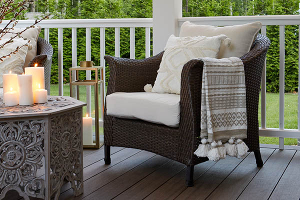 Front porch ideas for a cozy ambiance include textiles like throw blankets and pillows