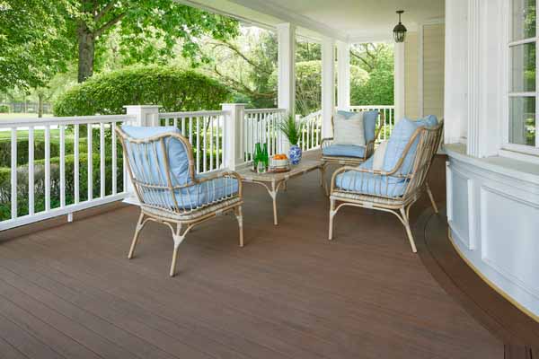 A porch features front porch ideas with a light blue and warm wood tone color scheme