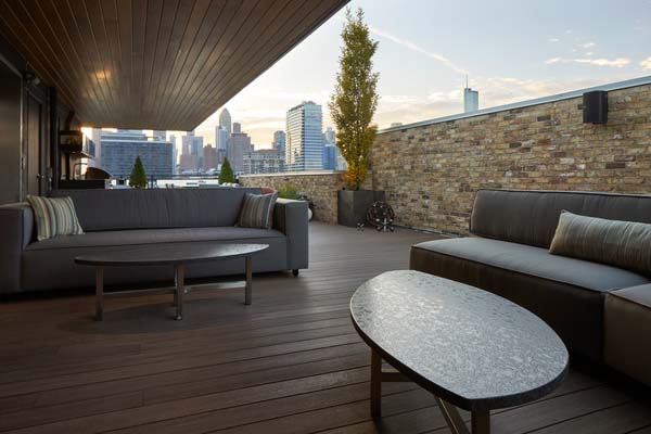 Rooftop deck ideas include a roof overhang for overhead protection