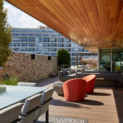 Rooftop deck designs include modern decor under an overhang