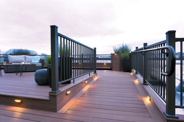 Rooftop deck designs include built-in deck lighting along an accessible ramp