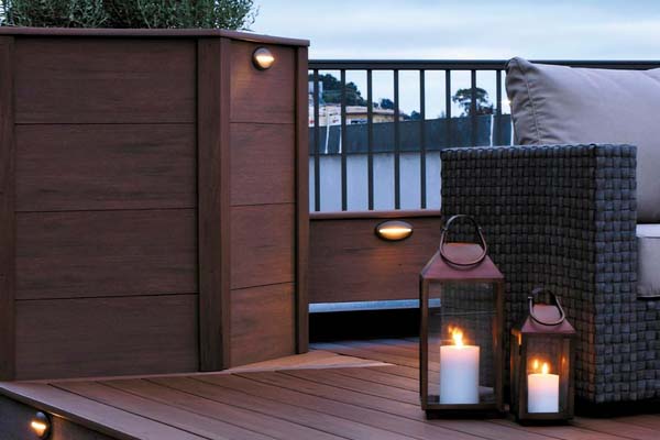 Rooftop deck designs include lanterns next to outdoor furniture