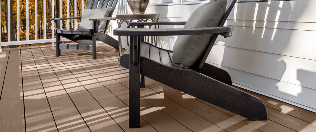 Two patio chairs look out on a deck built with Classic Brown composite deck boards
