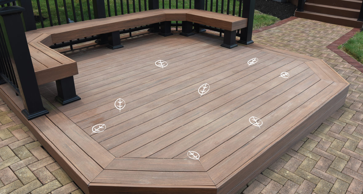 A composite deck is cleared of furniture with illustrated leaves on the surface to be cleared. 