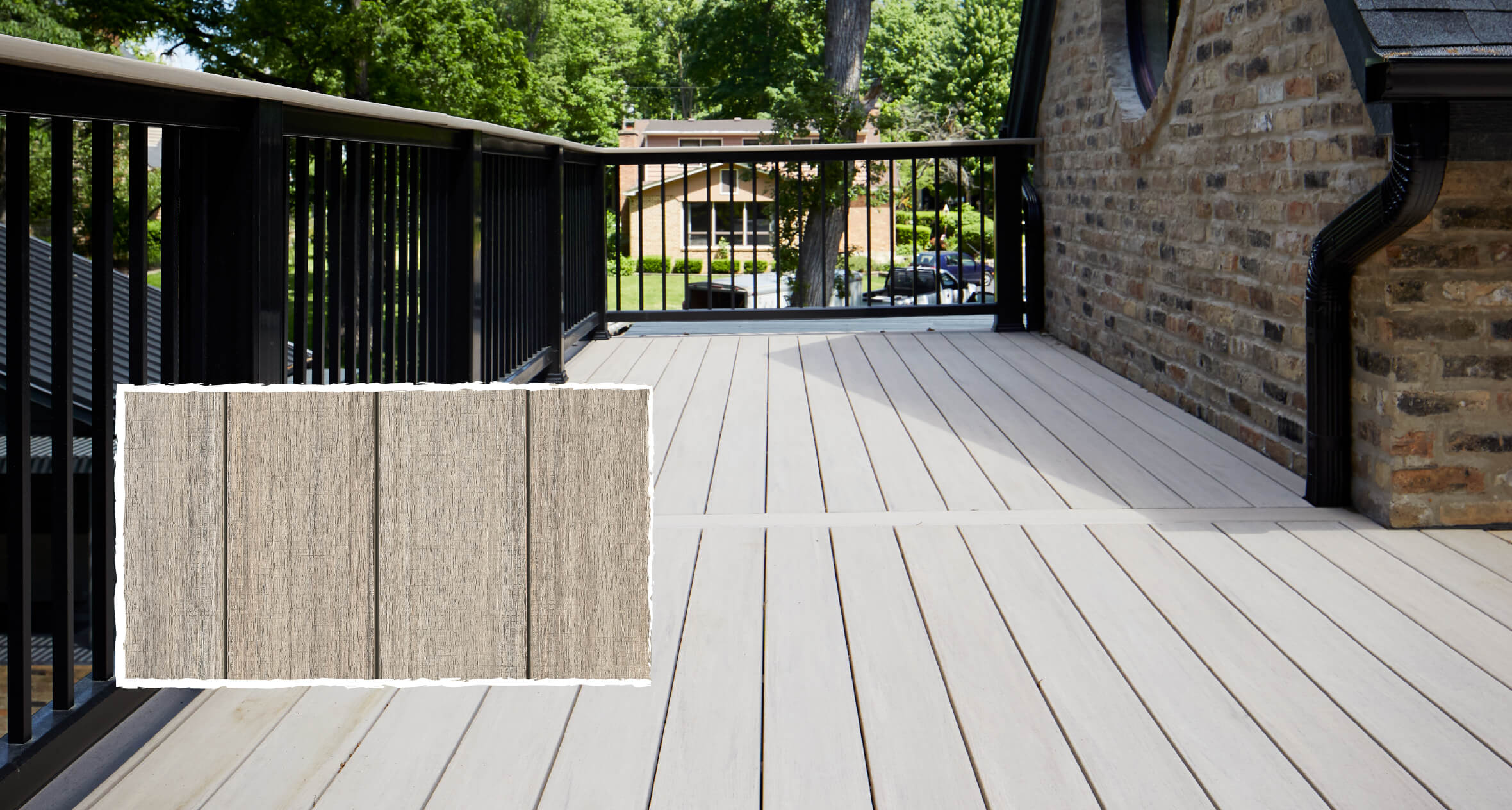 An example of a PVC deck in gray with black railing matching the black trim on a brick home. 