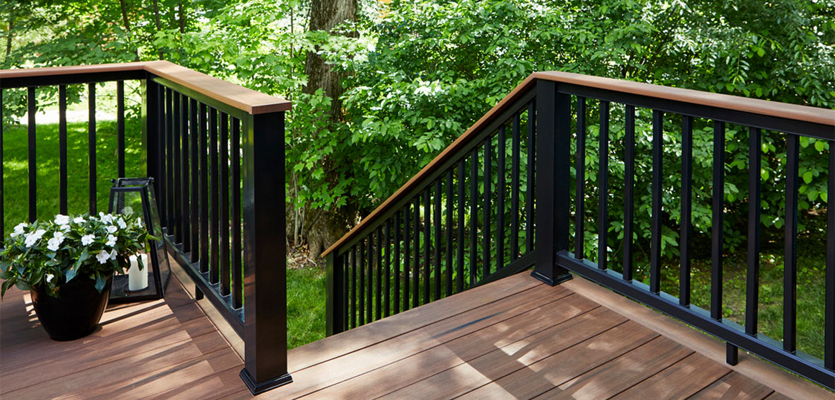 Wood deck with a black drink rail allows guests to set their drinks down.