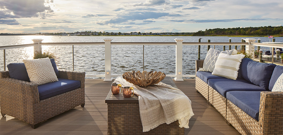 Navy blue outdoor seating on a deck overlooking the ocean.
