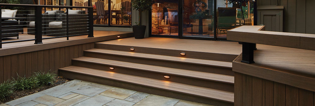 Extra-wide deck steps with lights provide a warm welcome to the deck and back door.