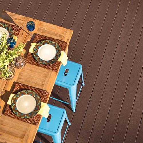 Outdoor dinner table set with contrasting blue stools