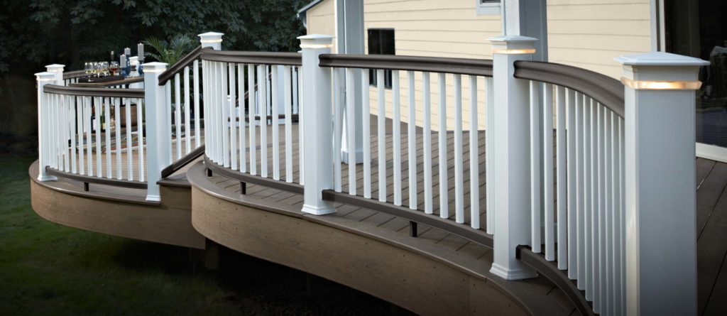 Curved railing with white infill and posts and a matte espresso colored top rail