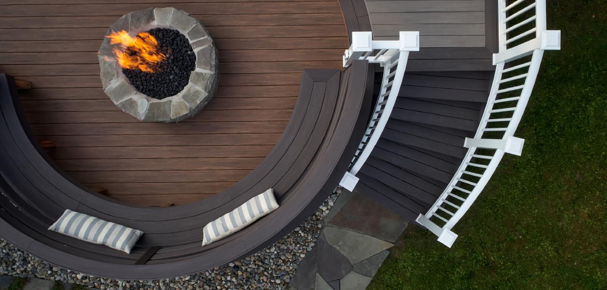 An overhead view shows a curved set of steps around a circular deck with a firepit and bench seating.