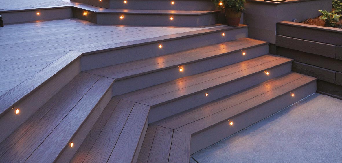 Lit deck steps connect a lower deck to a higher level part of the deck design.
