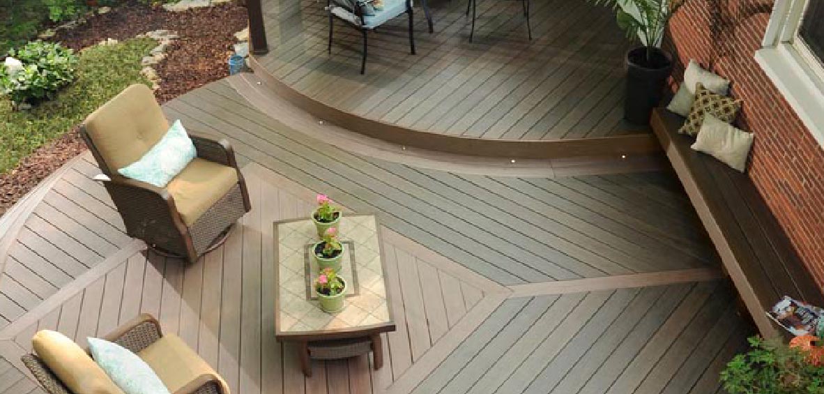 An overhead view of a deck shows curved shapes with mixed deck levels and a diamond pattern created with colored decking. 