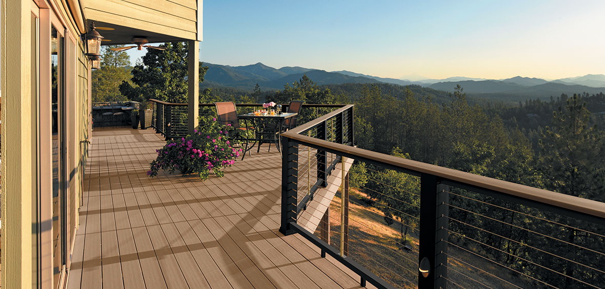 A raised deck features cable railing and a custom observation deck for a beautiful view of the mountains.