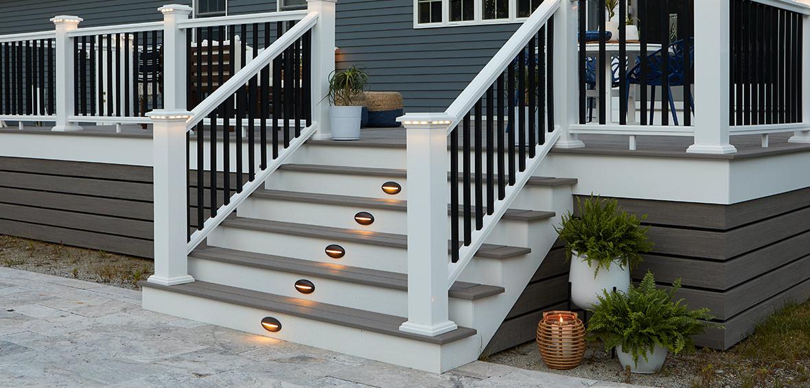 Outdoor deck stairs with riser lights installed in each step.