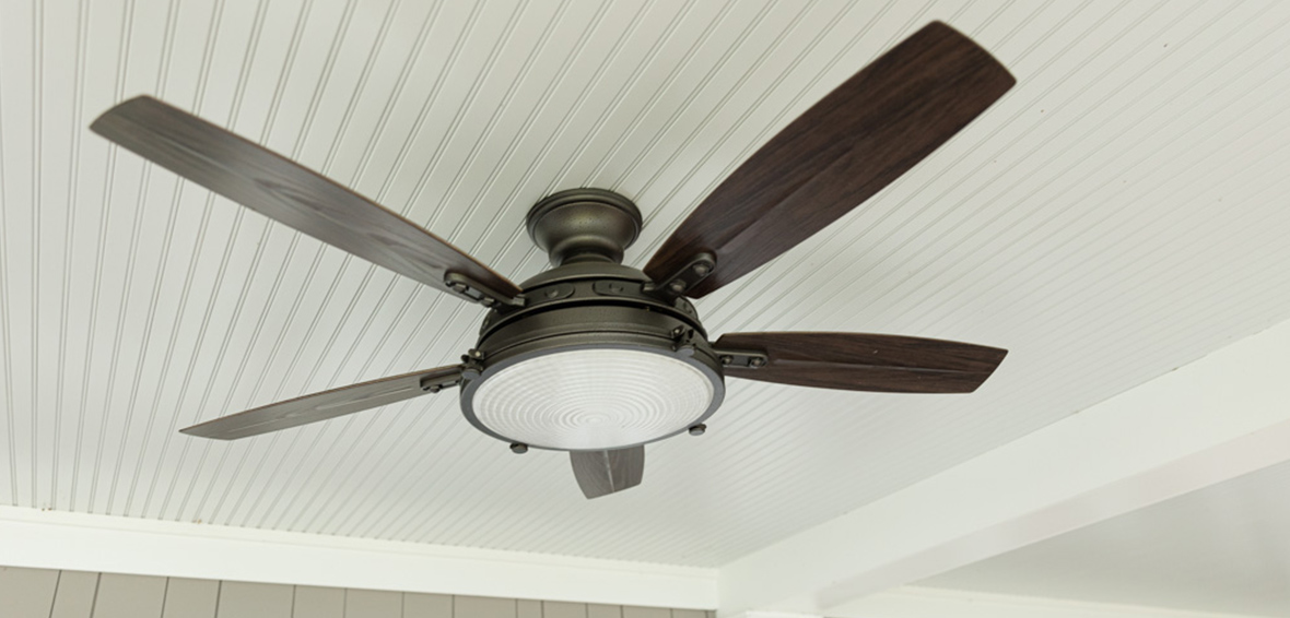 A ceiling over a deck features a ceiling fan and light fixture.