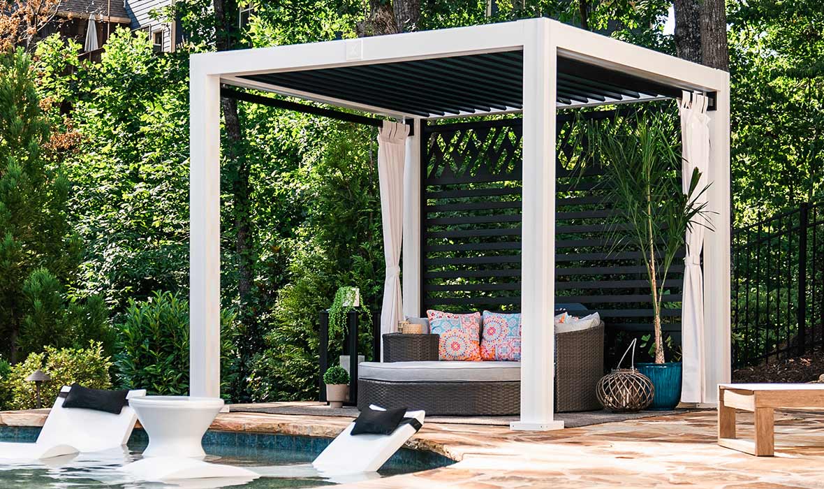 A poolside cabana helps protect a daybed from the summer sun.