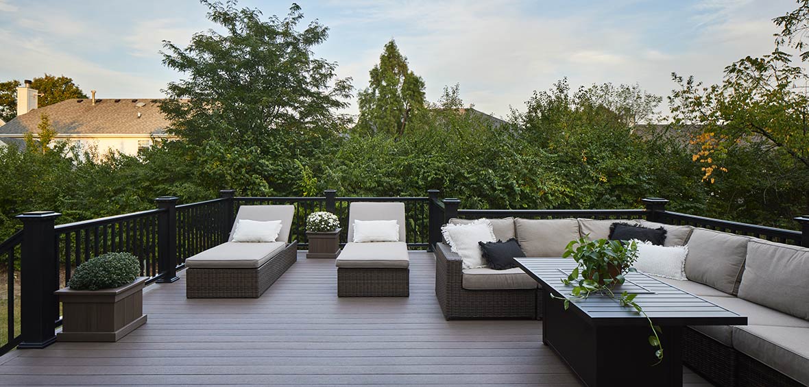 Two outdoor chaise lounges are placed side-by-side adjacent to a large sectional for plenty of seating. 