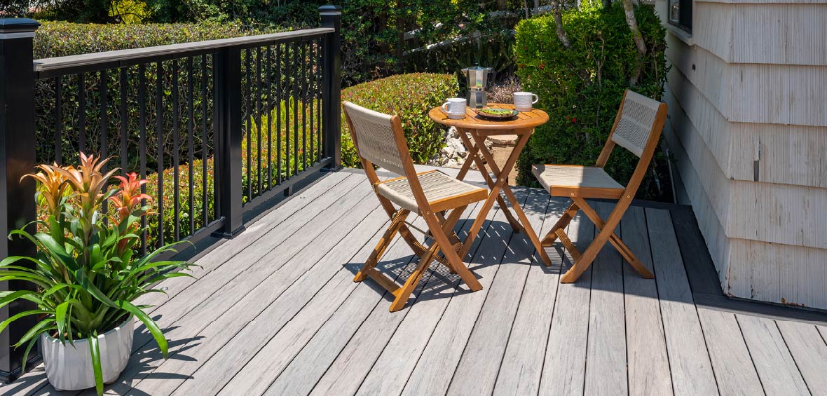 A small bistro table features breakfast staples in the corner of a deck. 