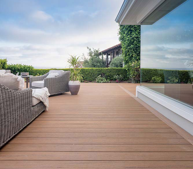 Full glass wall of a home and medium brown deck