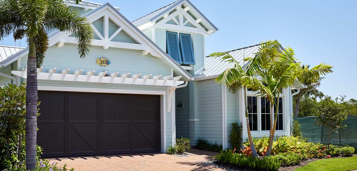 A blue home feature white accents and trim in decorative frames and overhangs for a custom look.