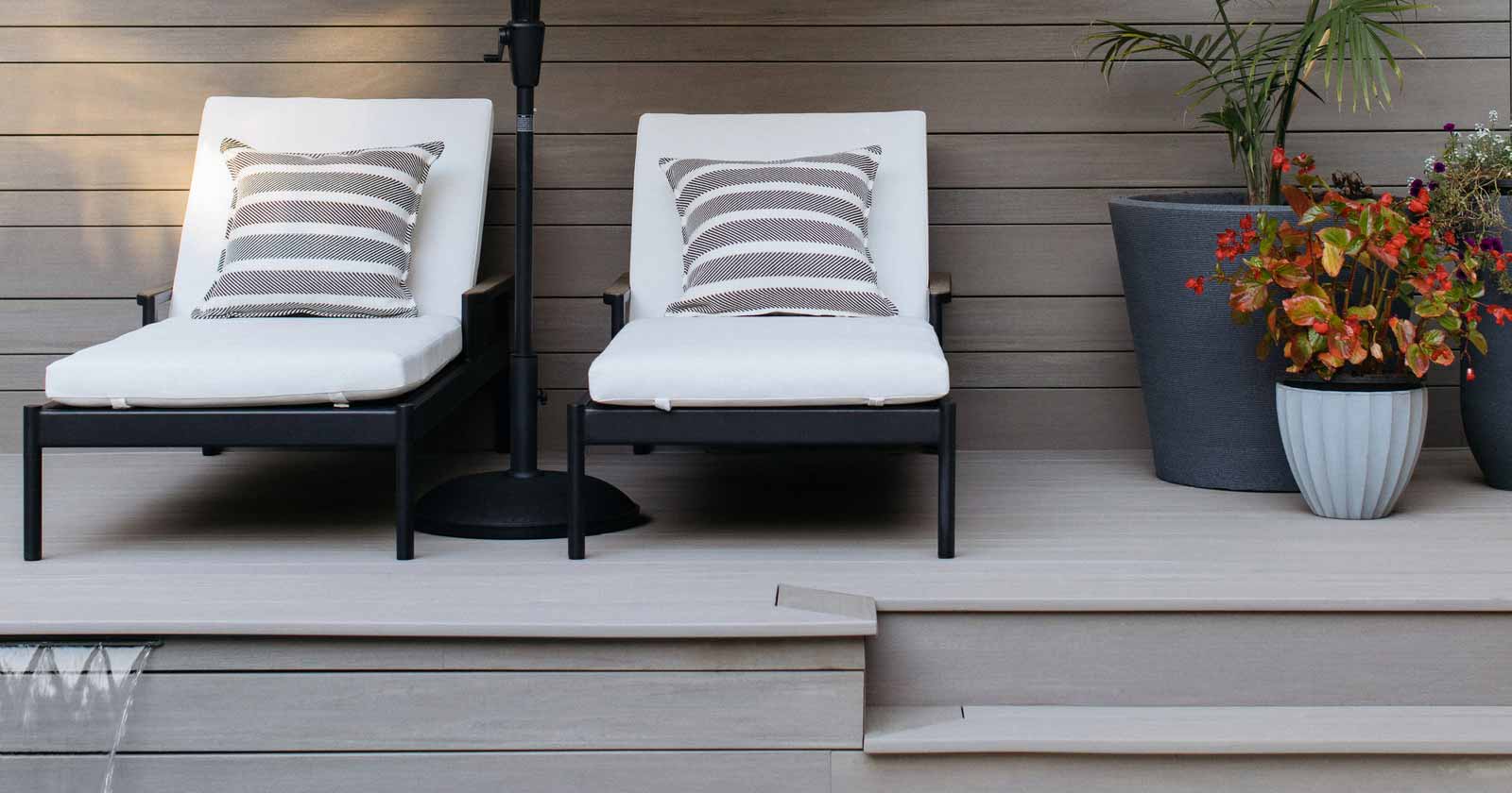 Gray pool deck with matching backboards and lounge chairs