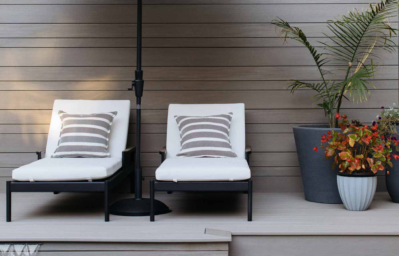 Gray pool deck with matching backboards and lounge chairs