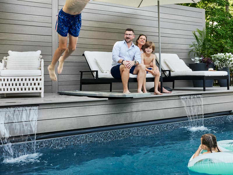 One of Elizabeth and Scott's sons dives into the pool while the family looks on