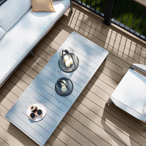 Aerial view of a light gray deck with shadows cast across it from the railing