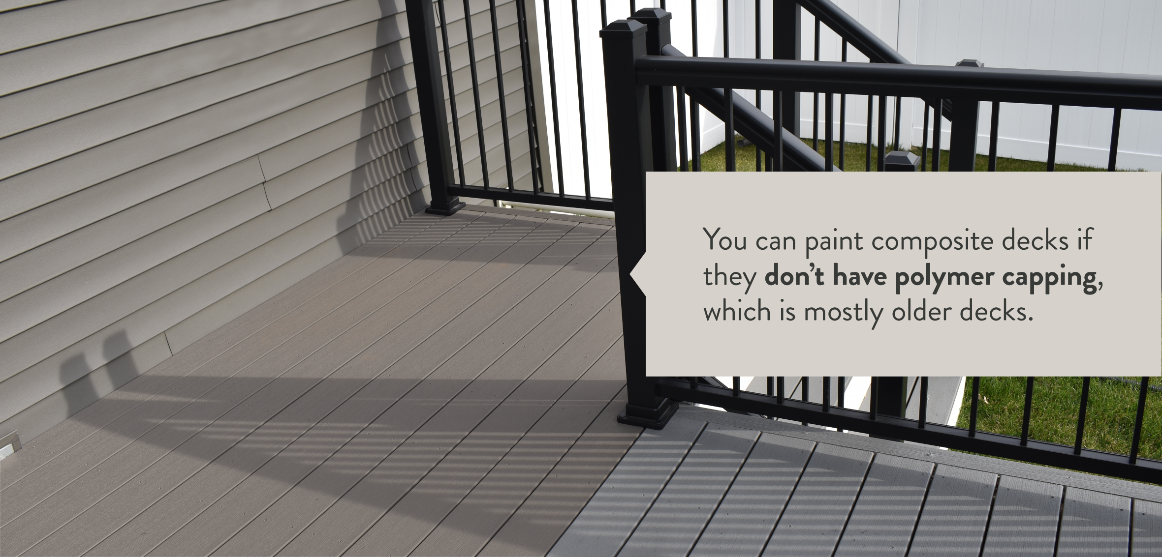 A cool gray deck with black railing is partially painted with the text "You can paint composite decks if they don't have polymer capping."