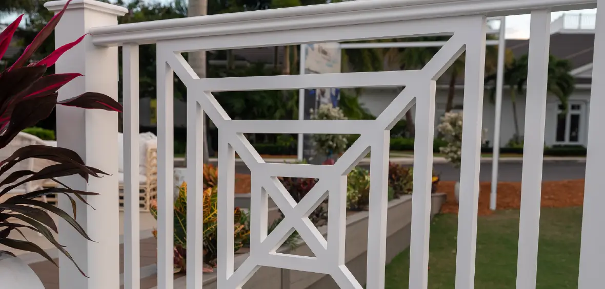 Close up of a white railing infill with a geometric pattern made of nested squares.